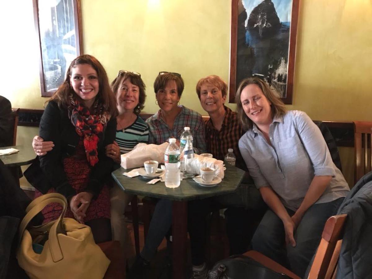 Colleen McGowan et al. sitting at a table posing for the camera