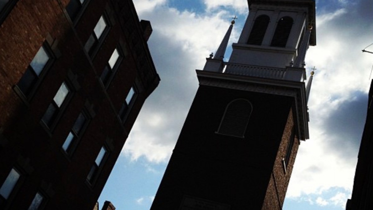 a large tall tower with a clock on the side of a building