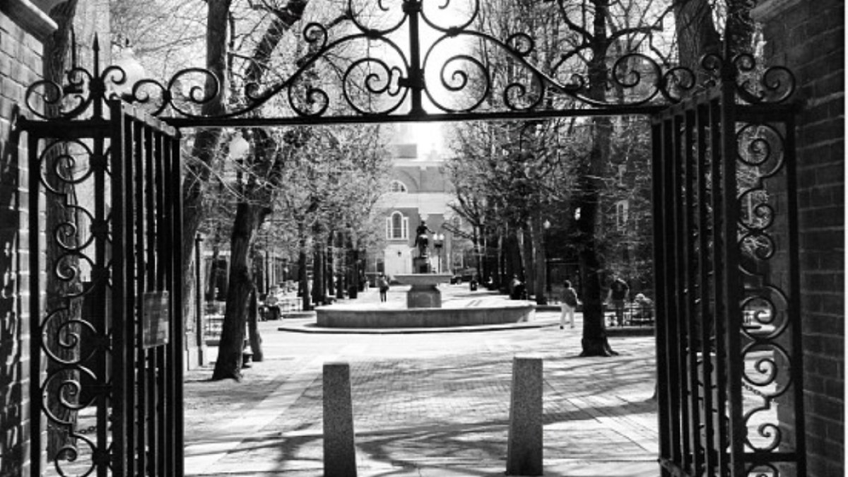 a clock in the middle of a park bench